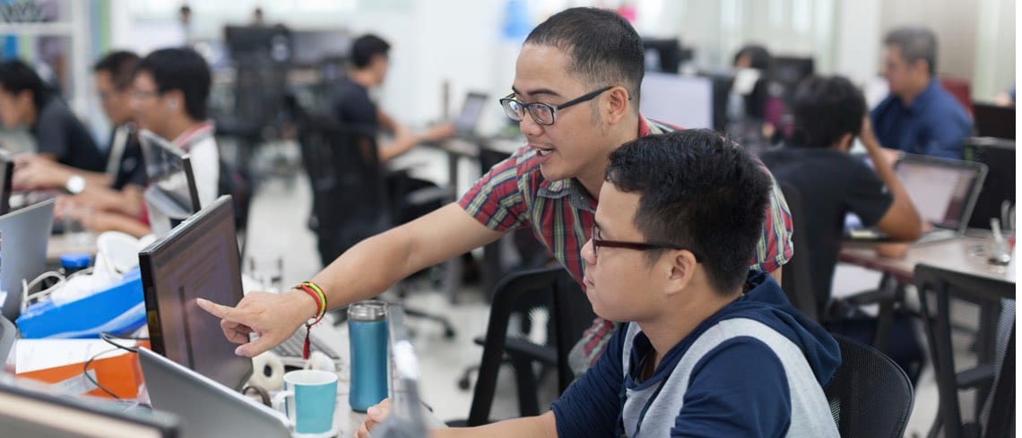 Students programming together