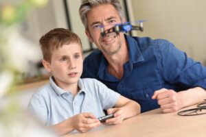 Father and son playing with a drone