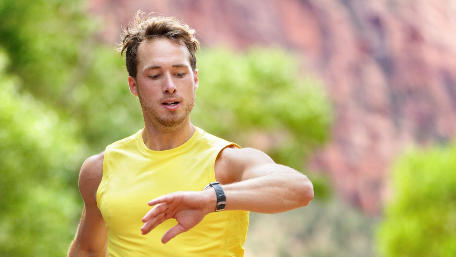 Runner looking at heart rate monitor smartwatch