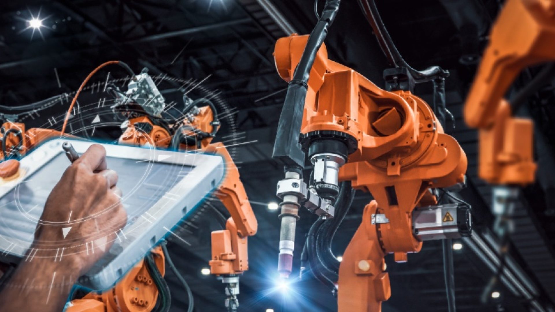 Engineer check and control welding heavy automation robot arm machine in smart factory industrial