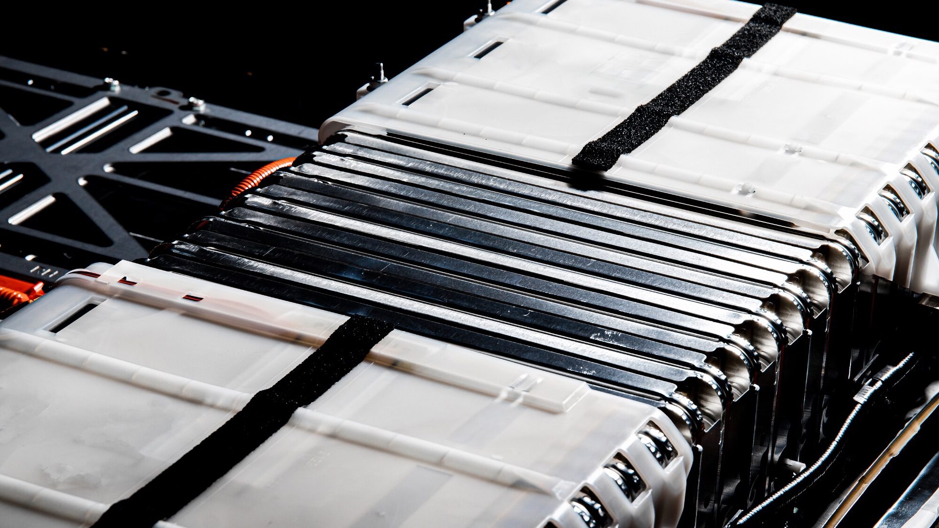 A group of lithium-ion cells of an electric car battery with elements of a heating system that prevents the battery from overcooling in winter. Frame with hard contrast lighting.; Shutterstock ID 2123679485; purchase_order: 1106262587; job: ; client: ; other: