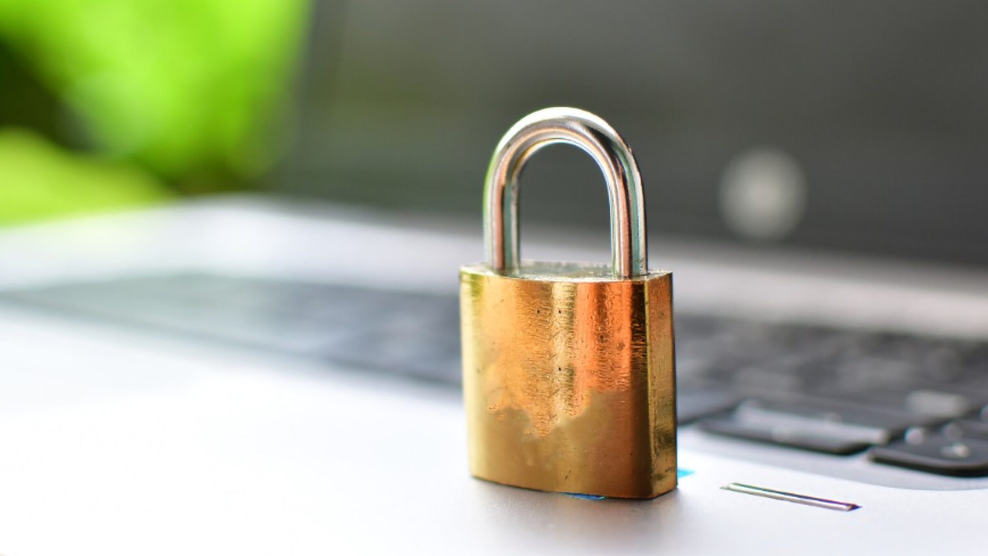 Cyber safety concept, locked and key on laptop computer keyboard ,key to unlock before green background.Key and Lock on Thai's keybroad ./golden lock on notebook ,thai keybroad; Shutterstock ID 652584118; purchase_order: 1106262587; job: ; client: 4000557855; other: