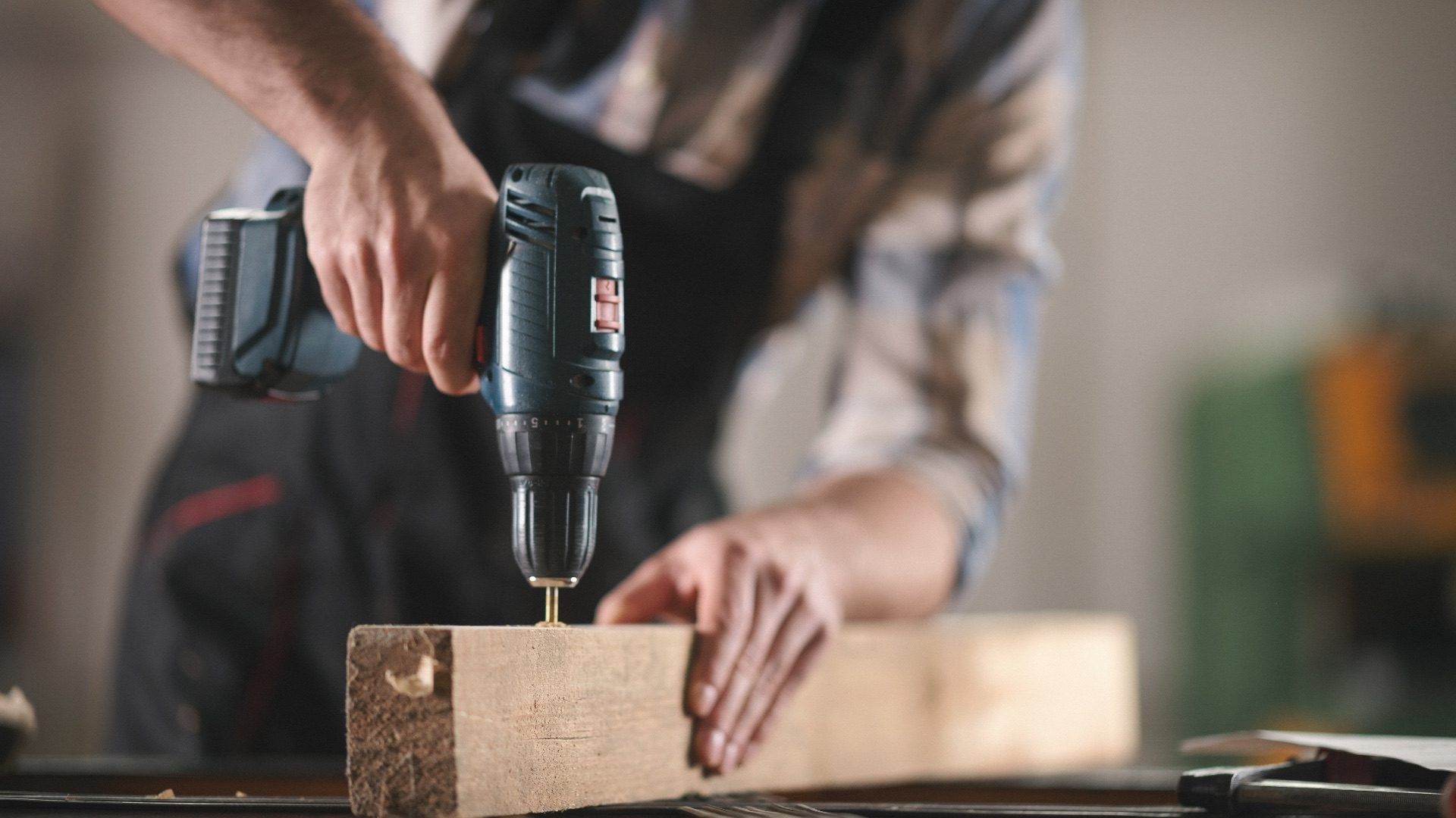 Young carpenter working in his workshop