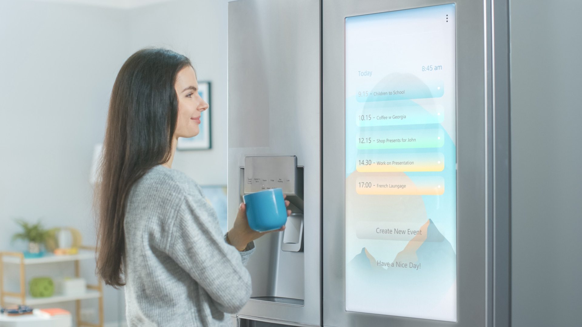 Beautiful Young Girl Stands Next to a Refrigerator While Drinking Her Morning Coffee. She is Checking the Weather Forecast and a To Do List on a Smart Fridge at Home. Kitchen is Bright and Cozy.; Shutterstock ID 1653473335; purchase_order: 1106262587; job: ; client: ; other: